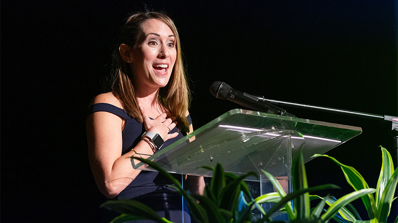 Image of a female speaker at podium