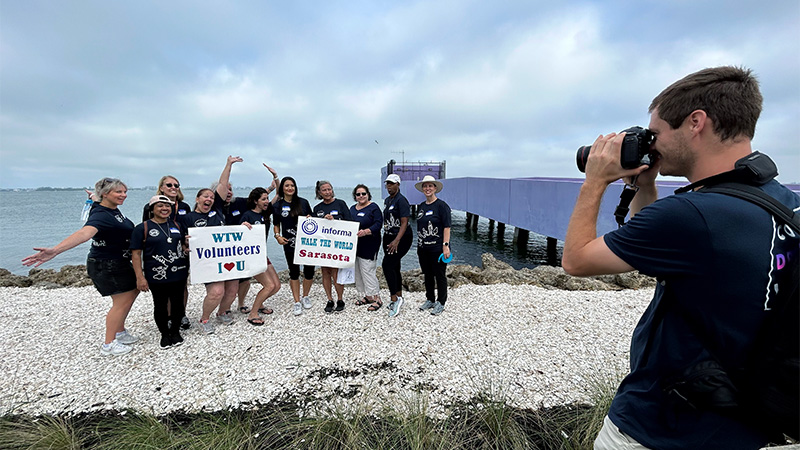 Volunteers being photographed at the beach